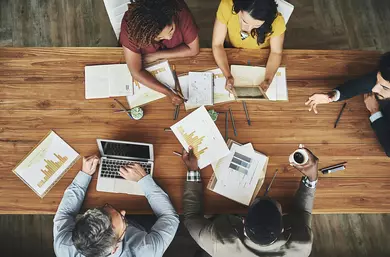 High angle shot of a team of businesspeople meeting around the boardroom table in the office
696570136